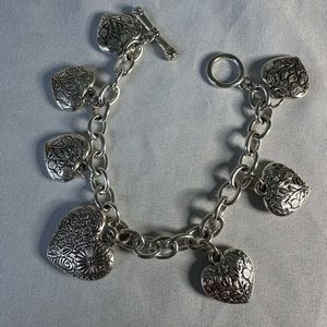 Silvertone hearts dangling on a toggle bracelet